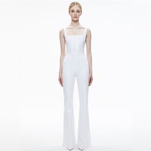 Brand New Alice and Olivia White Denim Jumpsuit. NWT. This is a size 29.